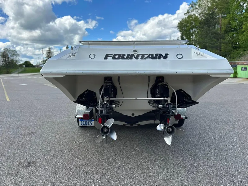 Slide: The Image of 1994 Fountain 35 Lightning boat rear view with dual propellers, parked outdoors. - 7