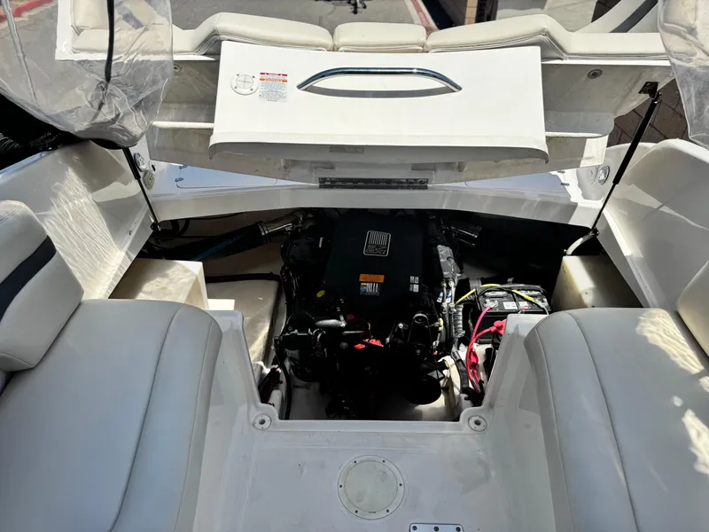 Slide: The Image of 2004 Chaparral 265 SSi boat engine compartment with seating and visible battery. - 10