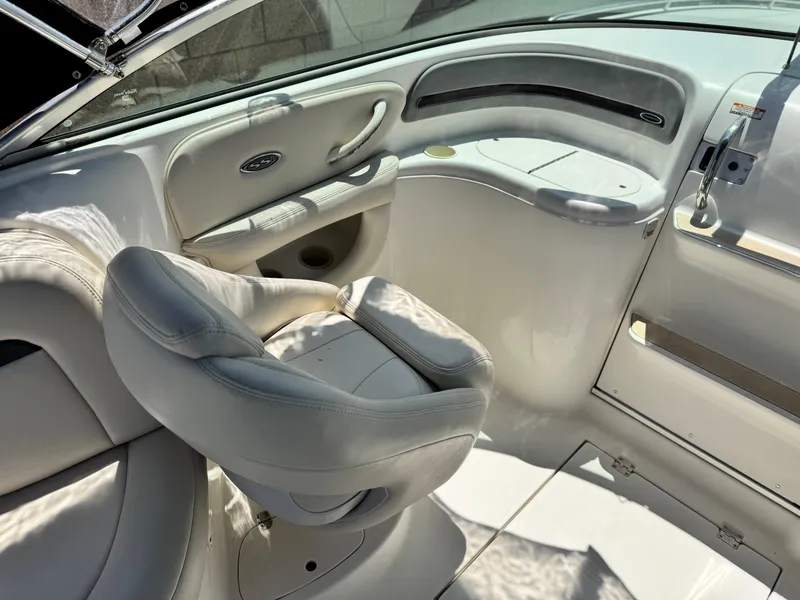 Slide: The Image of 2004 Chaparral 265 SSi boat interior with white seating and sleek design. - 12