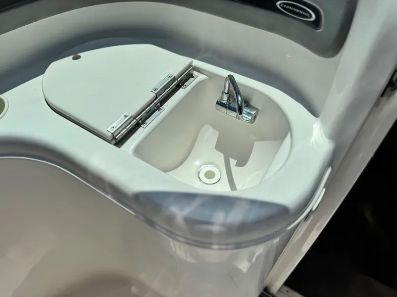 Slide: The Image of 2004 Chaparral 265 SSi boat sink with chrome faucet and closed lid. - 14