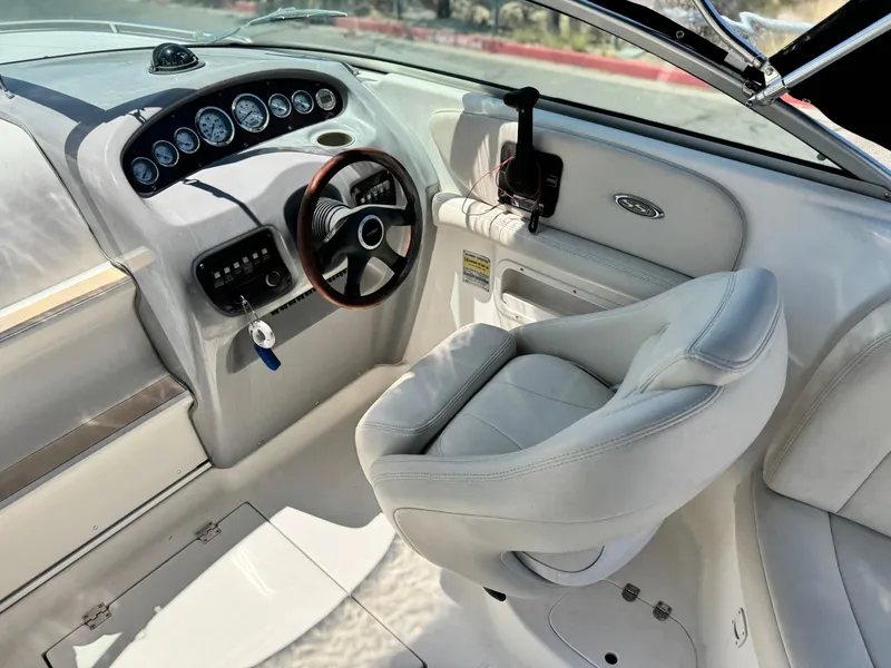 Slide: The Image of 2004 Chaparral 265 SSi boat interior with steering wheel and dashboard controls. - 16
