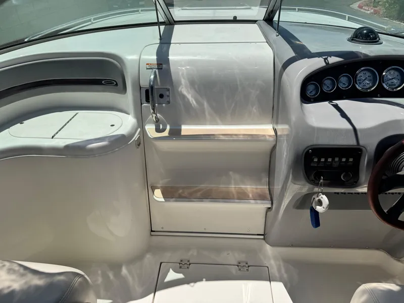 Slide: The Image of 2004 Chaparral 265 SSi boat interior dashboard with gauges and steering wheel. - 19