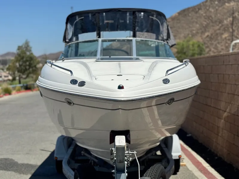 Slide: The Image of 2004 Chaparral 265 SSi boat on trailer, parked outdoors, sunny day. - 2