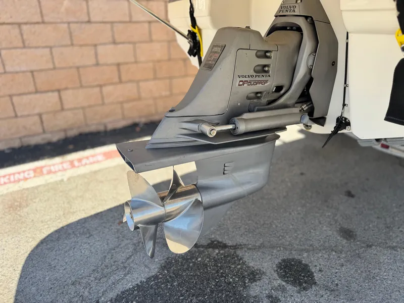 Slide: The Image of Volvo Penta outdrive on a 2004 Chaparral 265 SSi boat, parked on pavement. - 7