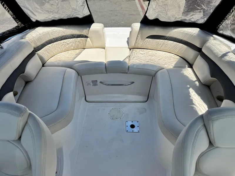 Slide: The Image of 2004 Chaparral 265 SSi boat interior with white leather seating and spacious layout. - 9