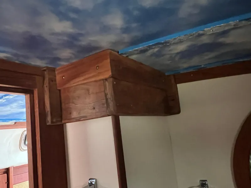 Slide: The Image of Interior of 1980 CAL 39 MK II Sloop with wooden cabinetry and sky-themed ceiling. - 11