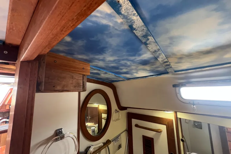 Slide: The Image of Interior of 1980 CAL 39 MK II Sloop with sky-themed ceiling and wooden accents. - 16