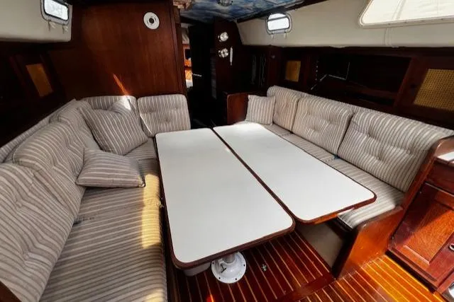 Slide: The Image of Interior of 1980 CAL 39 MK II Sloop with striped seating and wooden accents. - 2