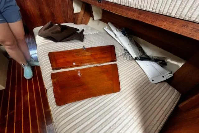 Slide: The Image of Interior of 1980 CAL 39 MK II Sloop with wooden panels and striped upholstery. - 21