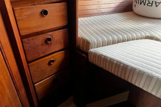 Slide: The Image of Interior of 1980 CAL 39 MK II Sloop with wooden drawers and striped cushions. - 22