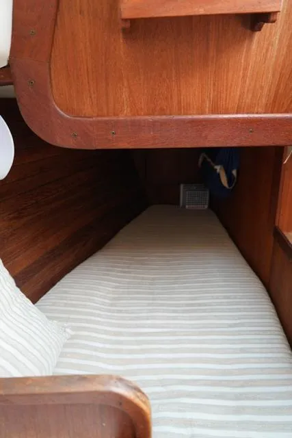 Slide: The Image of 1980 CAL 39 MK II Sloop cabin interior with wooden finish and striped bedding. - 24