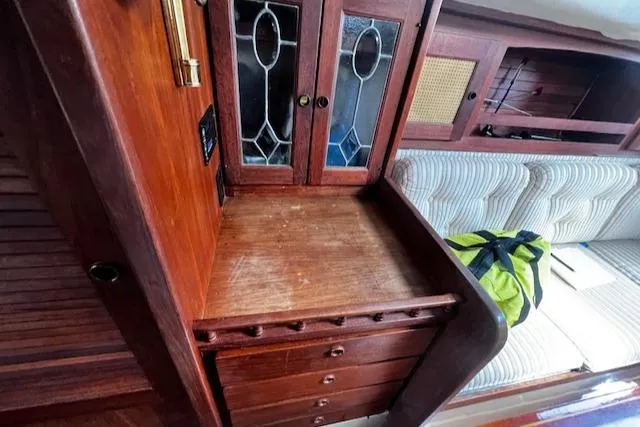 Slide: The Image of Interior of 1980 CAL 39 MK II Sloop with wooden cabinetry and cushioned seating. - 26