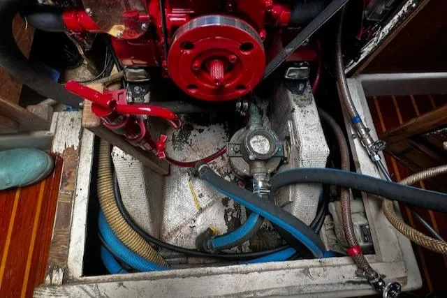 Slide: The Image of Engine compartment of 1980 CAL 39 MK II Sloop with visible hoses and components. - 33