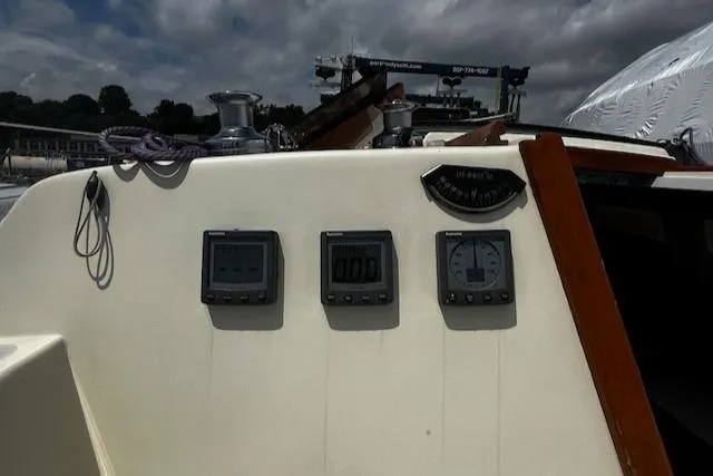 Slide: The Image of 1980 CAL 39 MK II Sloop cockpit with navigation instruments and winch under cloudy sky. - 35