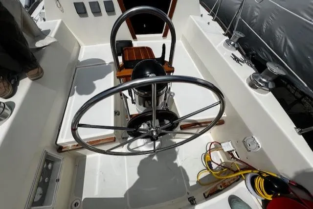 Slide: The Image of 1980 CAL 39 MK II Sloop cockpit with steering wheel and nautical equipment. - 37