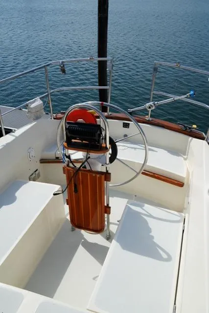 Slide: The Image of 1980 CAL 39 MK II Sloop cockpit with steering wheel, overlooking calm water. - 38