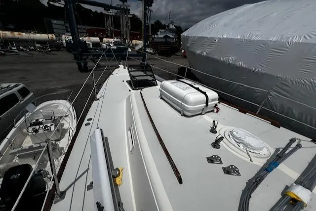 Slide: The Image of 1980 CAL 39 MK II Sloop on deck, docked with equipment and lifeboat visible. - 43