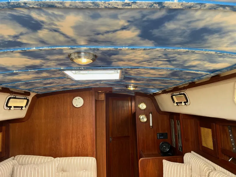Slide: The Image of Interior of 1980 CAL 39 MK II Sloop with sky-themed ceiling and wooden accents. - 7