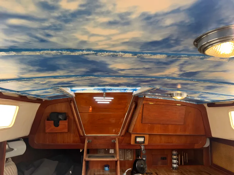 Slide: The Image of Interior of 1980 CAL 39 MK II Sloop with sky-themed ceiling and wooden cabinetry. - 8