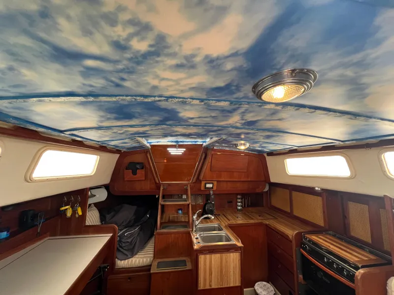 Slide: The Image of Interior of 1980 CAL 39 MK II Sloop with wood finish and sky-themed ceiling. - 9