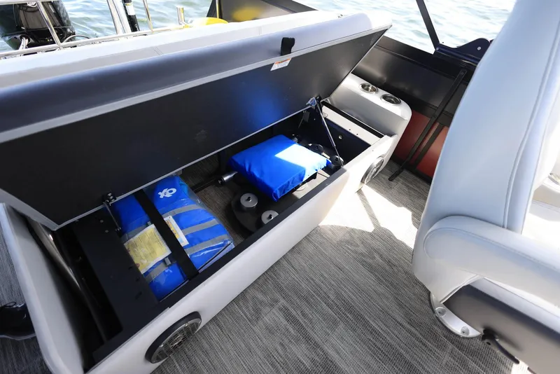 Slide: The Image of Open storage compartment on Viaggio DIAMANTE 23S boat, showcasing blue life jackets and equipment. - 14