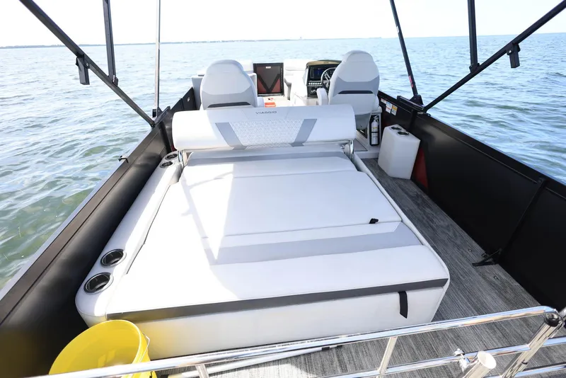 Slide: The Image of 2023 Viaggio DIAMANTE 23S boat interior with seating, on a calm water body. - 15