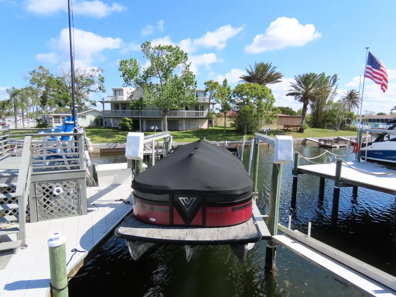 Slide: The Image of 2023 Viaggio DIAMANTE 23S boat docked at a marina with American flag. - 17