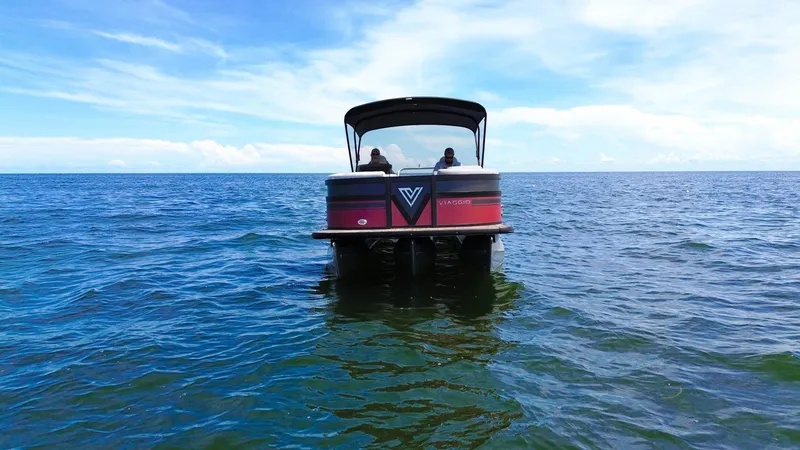 Slide: The Image of 2023 Viaggio DIAMANTE 23S pontoon boat on open water under blue sky. - 2
