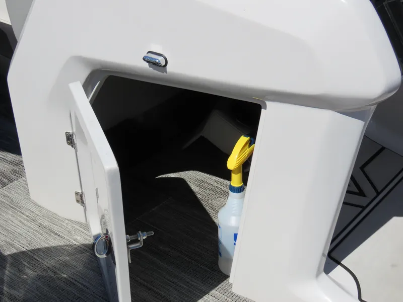 Slide: The Image of Open storage compartment on Viaggio DIAMANTE 23S boat, revealing cleaning supplies. - 22