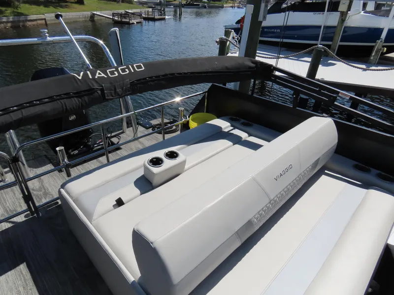 Slide: The Image of 2023 Viaggio DIAMANTE 23S boat with sleek seating and cup holders by the water. - 23