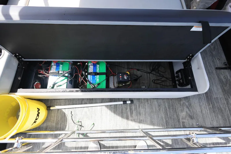 Slide: The Image of Open storage compartment in Viaggio DIAMANTE 23S boat showing batteries and equipment. - 27
