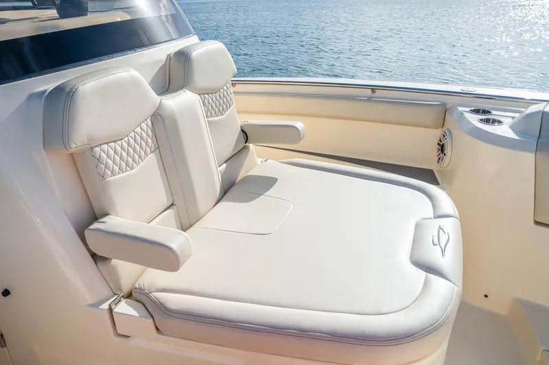 Slide: The Image of Luxurious seating on 2026 Scout 288 LXF boat, featuring elegant design and ocean backdrop. - 11