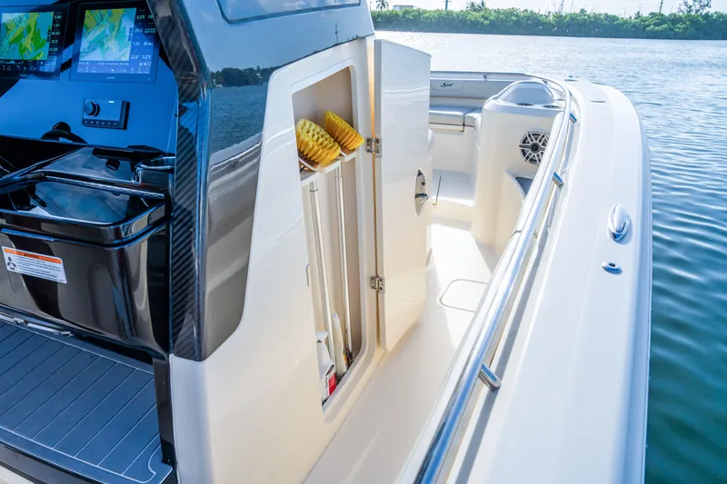 Slide: The Image of 2026 Scout 288 LXF boat interior with open storage compartment and navigation screens. - 22