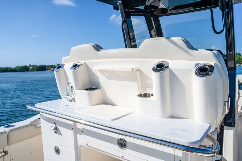 Slide: The Image of 2026 Scout 288 LXF boat interior with sleek white console and cup holders. - 23