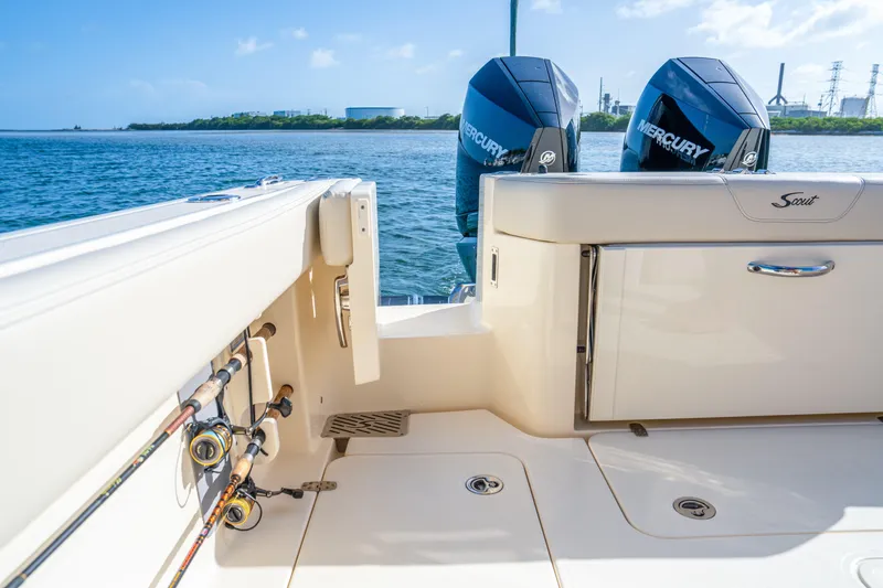 Slide: The Image of 2026 Scout 288 LXF boat with dual Mercury engines, fishing rods, and scenic water view. - 28