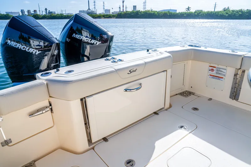 Slide: The Image of 2026 Scout 288 LXF boat with dual Mercury engines on a sunny day. - 29