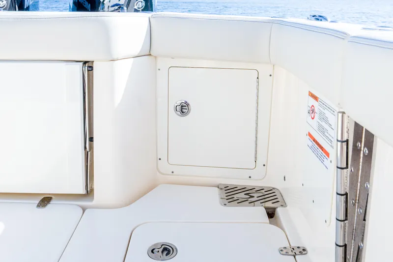 Slide: The Image of 2026 Scout 288 LXF boat interior with storage compartment and seating. - 33