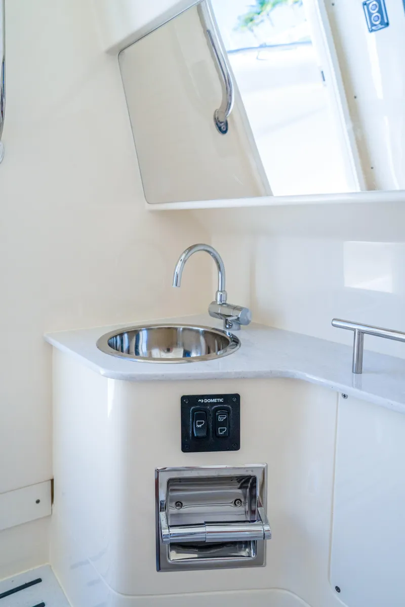 Slide: The Image of 2026 Scout 288 LXF boat interior with sink and storage compartment. - 37