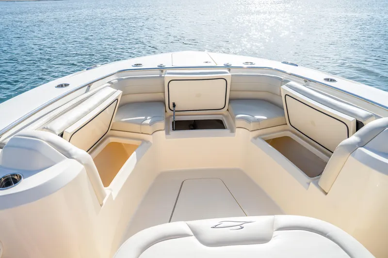 Slide: The Image of 2026 Scout 288 LXF boat interior with cushioned seating and storage compartments. - 7