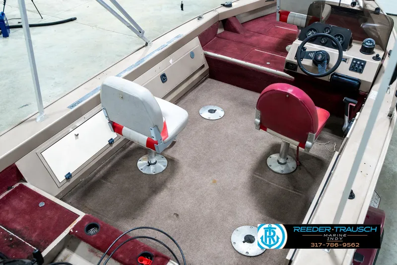 Slide: The Image of 1997 Lund 1700 Pro Angler boat interior with red and white seating, steering console. - 13
