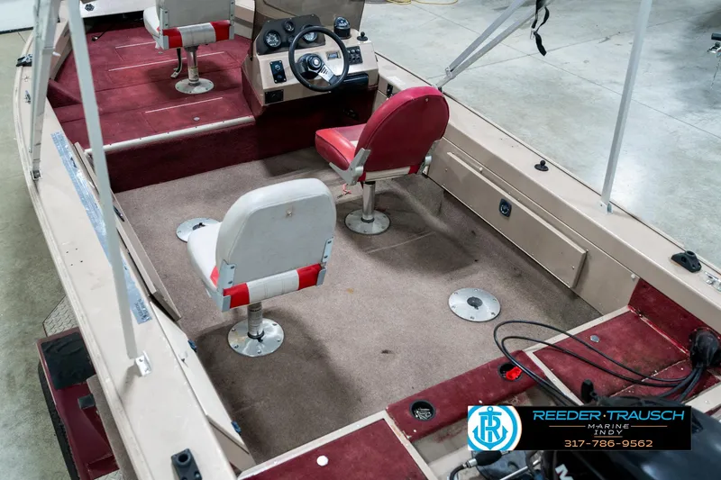 Slide: The Image of 1997 Lund 1700 Pro Angler boat interior with red and white seating. - 14