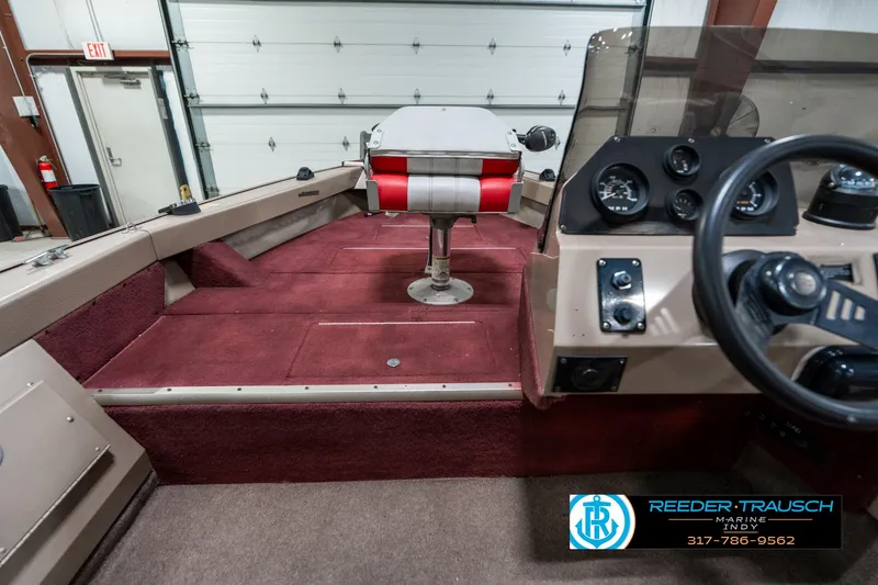 Slide: The Image of 1997 Lund 1700 Pro Angler boat interior with red carpet and steering console. - 19