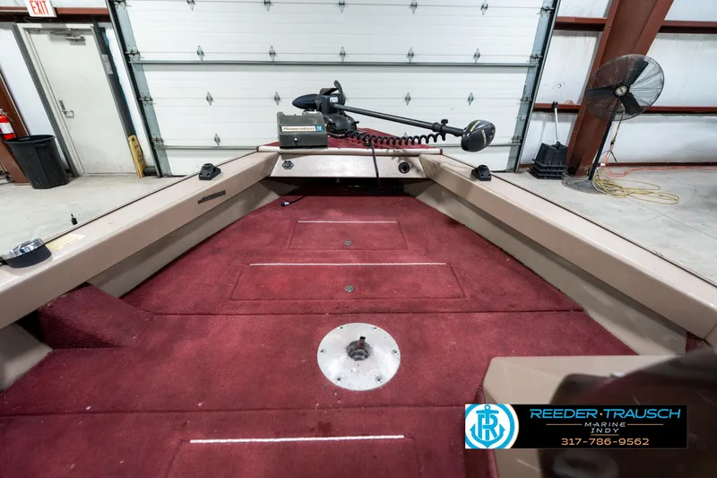 Slide: The Image of 1997 Lund 1700 Pro Angler boat interior with red carpet and trolling motor. - 20