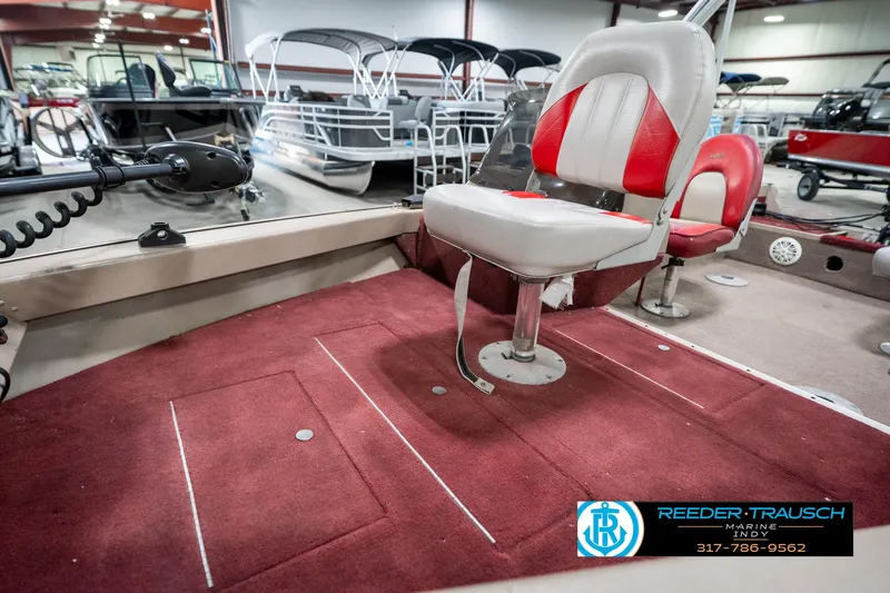 Slide: The Image of 1997 Lund 1700 Pro Angler boat interior with red carpet and swivel seat. - 21