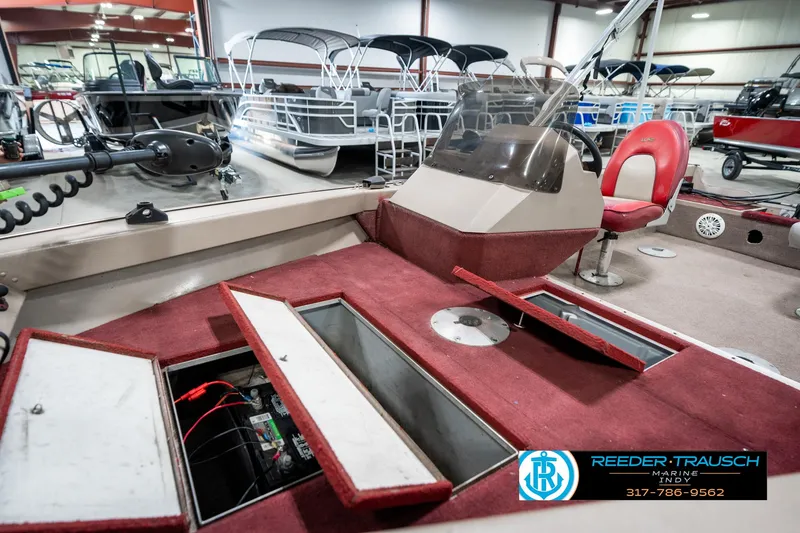 Slide: The Image of 1997 Lund 1700 Pro Angler boat interior with storage compartments and red seating. - 23