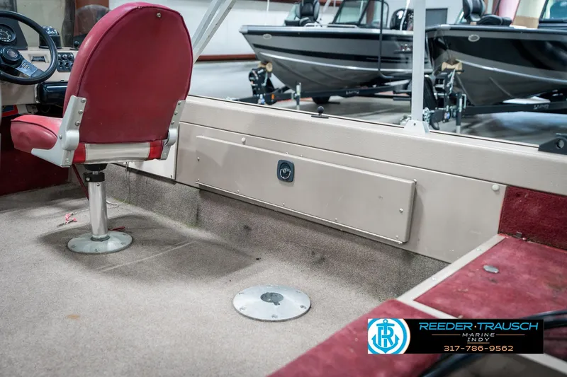 Slide: The Image of 1997 Lund 1700 Pro Angler boat interior with red seating and carpeted flooring. - 24
