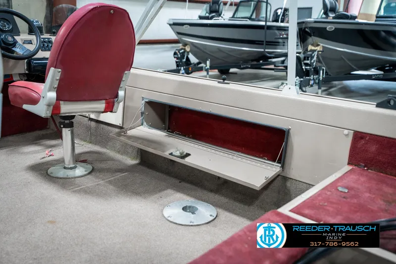 Slide: The Image of 1997 Lund 1700 Pro Angler boat interior with red seating and storage compartment. - 25
