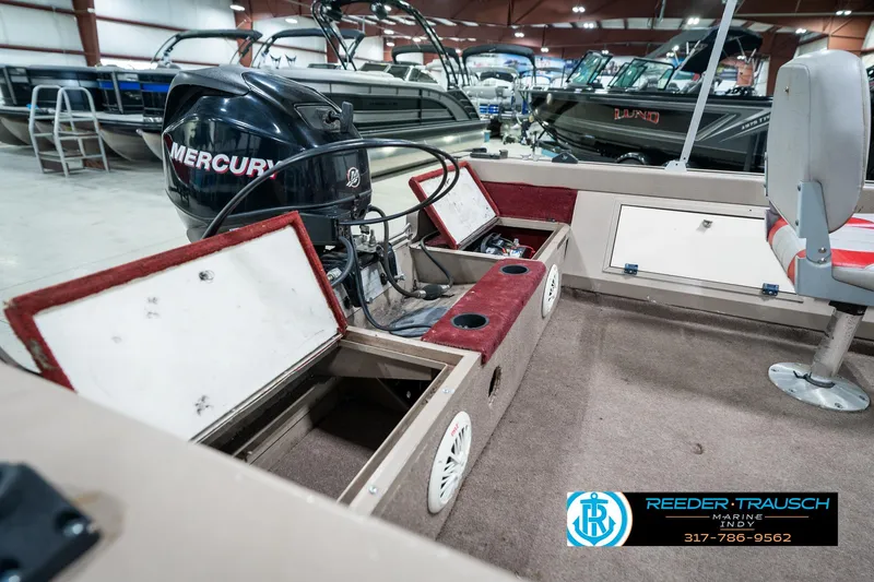 Slide: The Image of 1997 Lund 1700 Pro Angler boat interior with Mercury engine in showroom. - 29