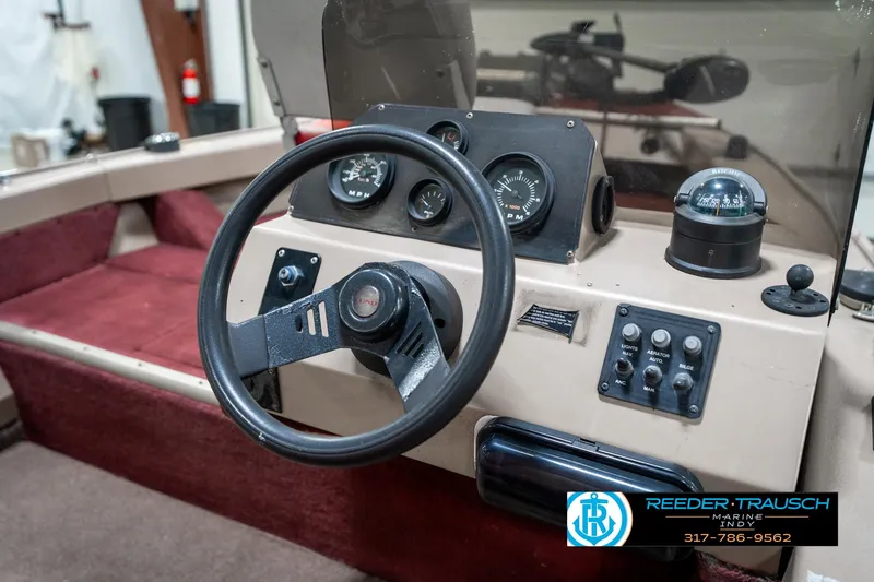 Slide: The Image of 1997 Lund 1700 Pro Angler boat dashboard with steering wheel and gauges. - 30