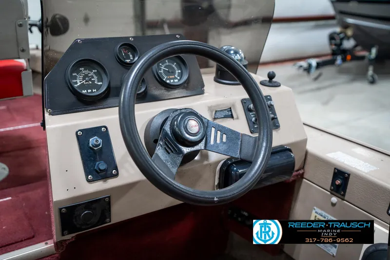 Slide: The Image of 1997 Lund 1700 Pro Angler dashboard with steering wheel and gauges. - 31